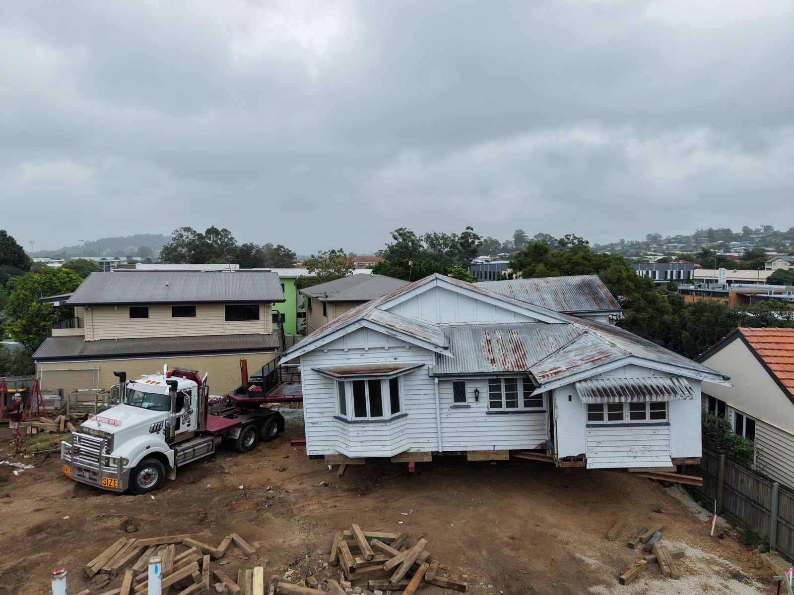 Aerial view of a Queenslander being moved off its block